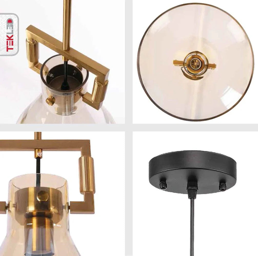 Крупный план абажура из бронзового металла и янтарного стекла, подходящий для современных интерьеров и столовых.