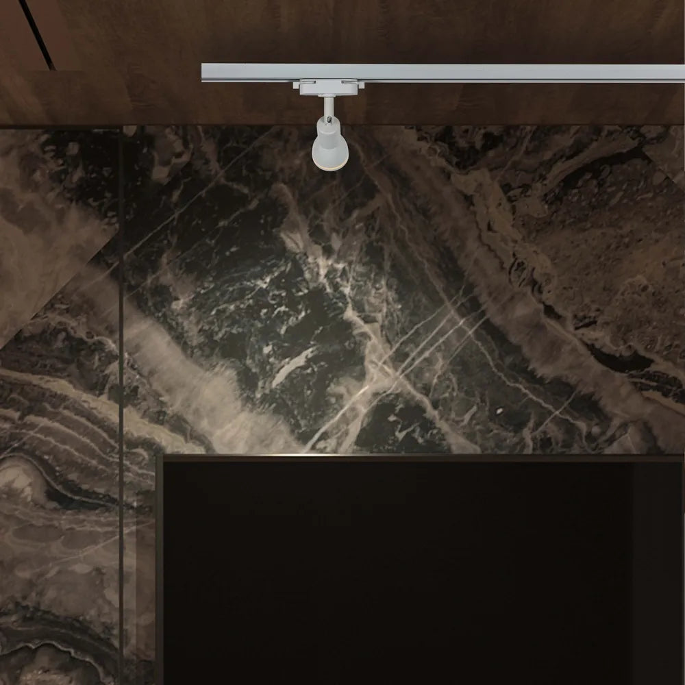 Sleek Luma GU10 track light illuminating a modern living room with contemporary decor and vibrant artwork on the walls.173-03020